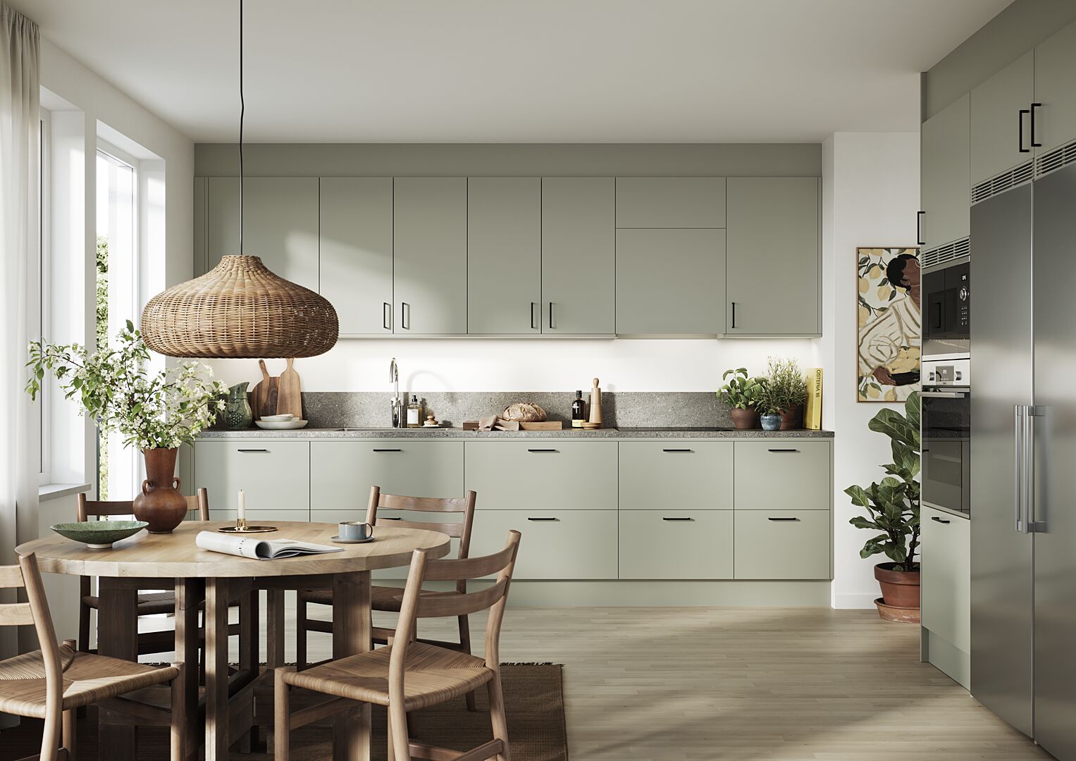Kök med ljus matplats, gröna skåp, träbord och moderna vitvaror