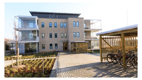 Inflyttningsklar lägenhet i modern flerbostadsbyggnad med cykelparkering och gård