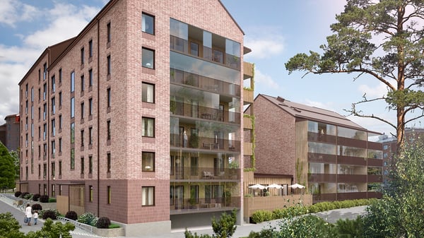 Exteriörbild av moderna flerbostadshus i tegel med balkonger och omgivande grönska