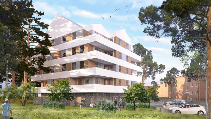 Flerfamiljshus omgivet av träd